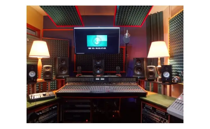 Professional recording studio setup with a large mixing console